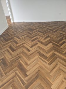 Textures LVT Fitted Herringbone style in the colour Warm Walnut in a beautiful home In Tytherington