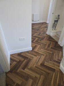 Textures LVT Fitted Herringbone style in the colour Warm Walnut in a beautiful home In Tytherington
